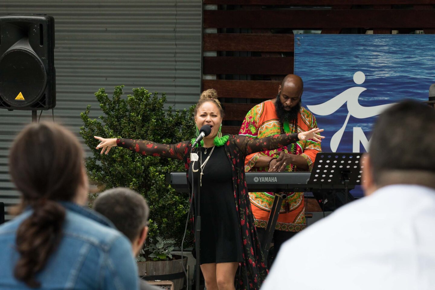 A jazz singing stretches her arms out as she belts a tune