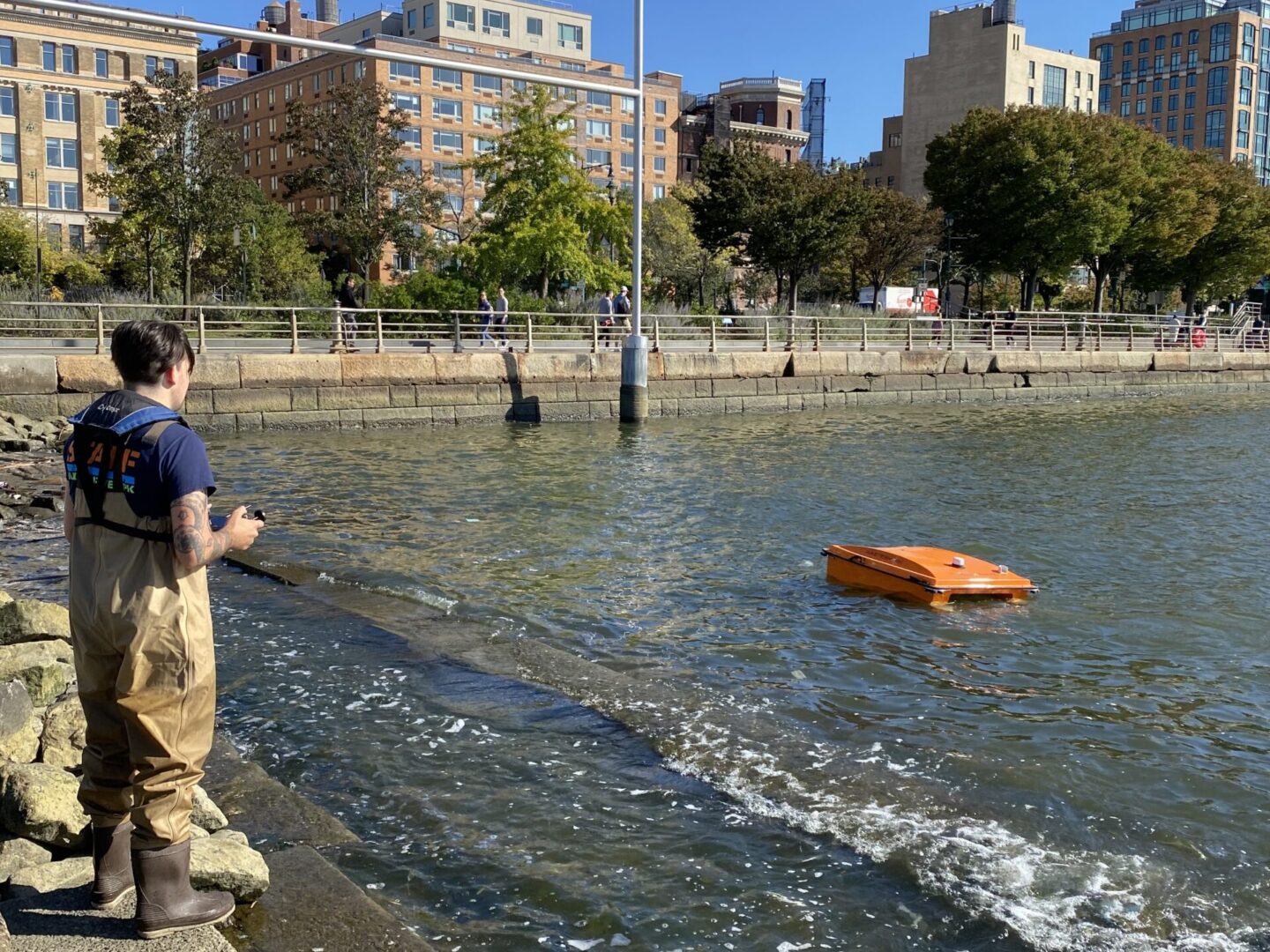 An HRPK River Project worker operating a WasteShark at Gansevoort Peninsula