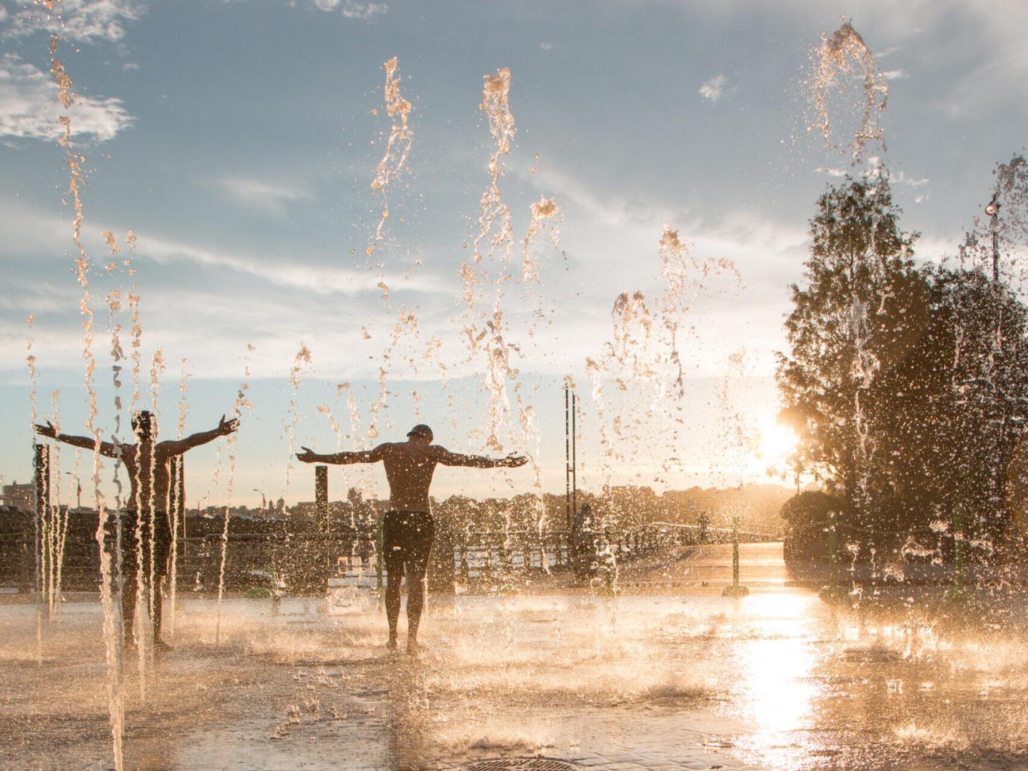 Two park visitors stand in the fountain area at Pier 84