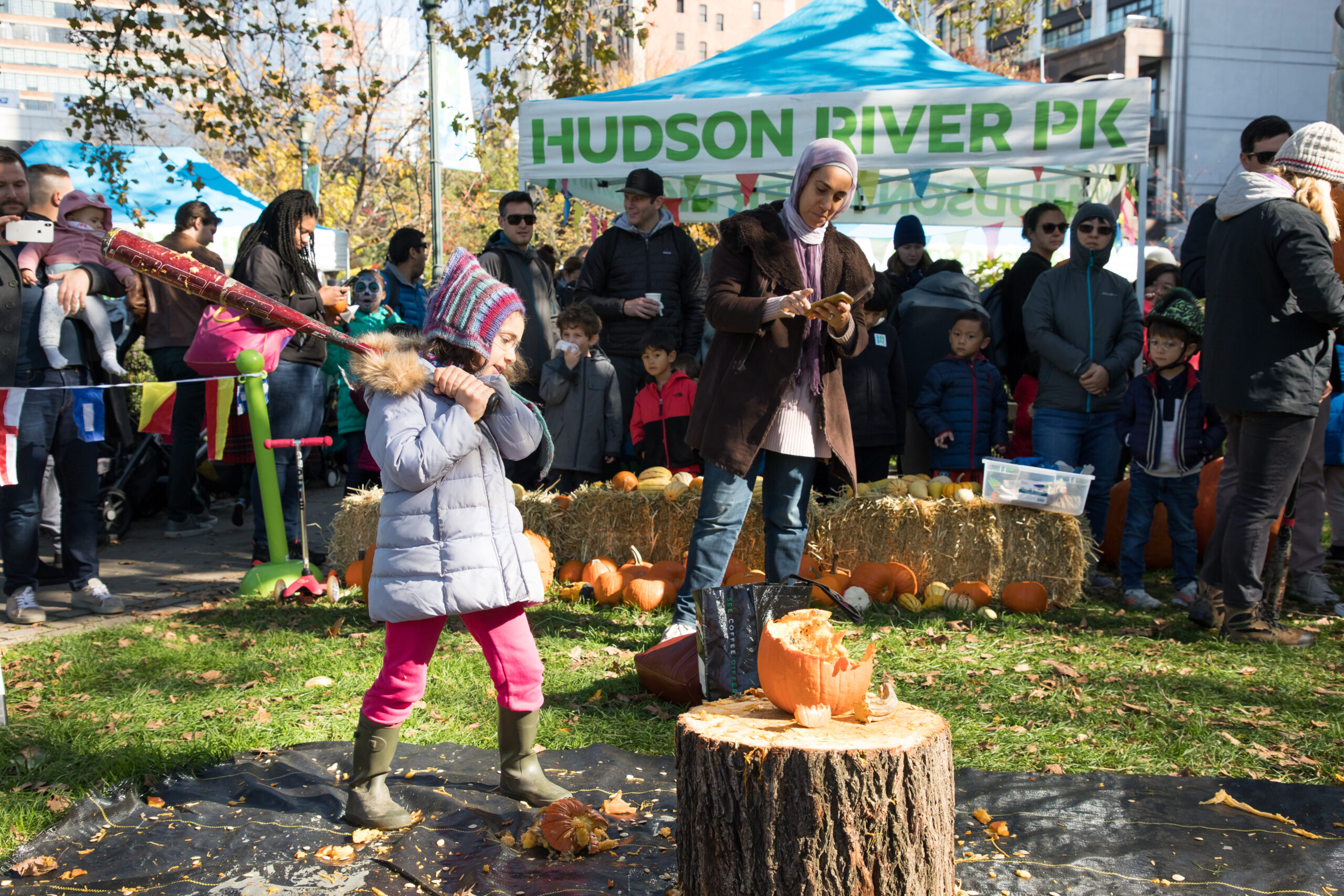 Kid smashing a pumpkin at pumpkin smash